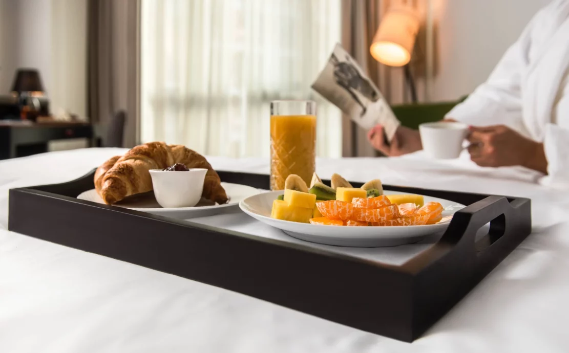in-room breakfast inside a superior room with orange juice, croissants and eggs at the CUE hotel in Montenegro
