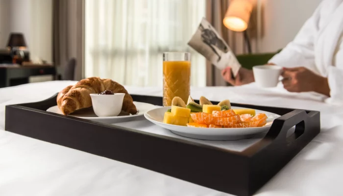 in-room breakfast inside a superior room with orange juice, croissants and eggs at the CUE hotel in Montenegro