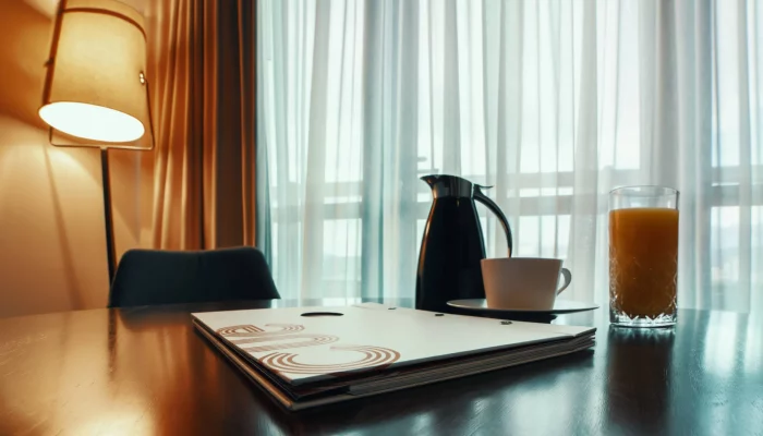 a tea kettle on a table next to a magazine